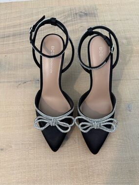 BCBGeneration Black Pointed Toe Ankle-Strap Pumps with Rhinestone Bow